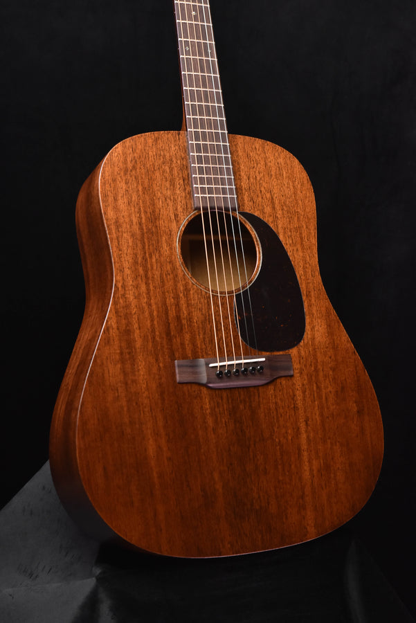 Brown dreadnought acoustic guitar front with black pickguard and circular sound hole
