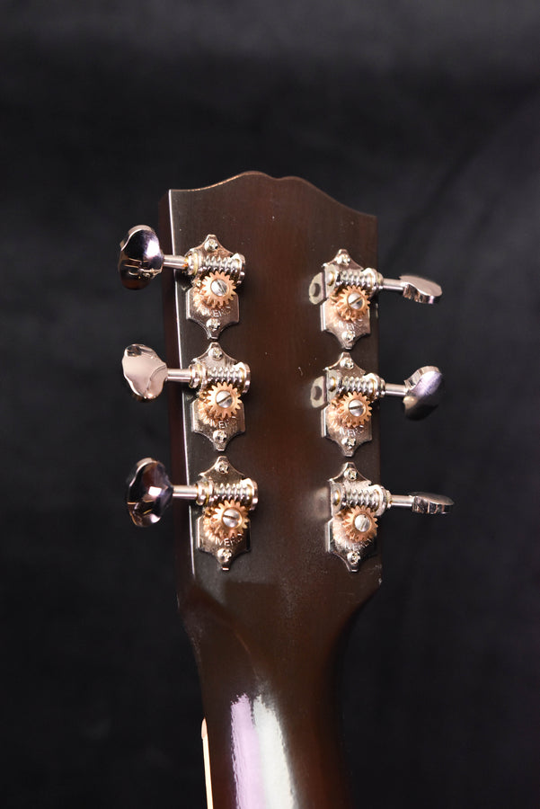Gibson headstock close-up with silver tuning pegs and ornate plates
