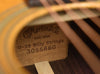 Close-up of D-28 Billy Strings label on acoustic guitar soundboard