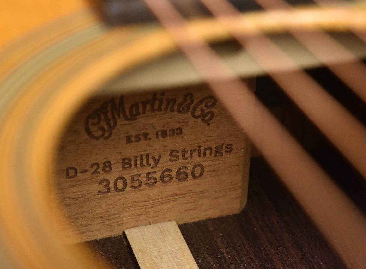 Close-up of D-28 Billy Strings label on acoustic guitar soundboard