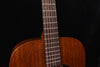 Acoustic guitar neck and fretboard with frets and strings, close-up view