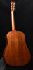 Brown acoustic guitar back with smooth finish and curved body shape