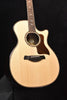 Natural acoustic guitar front with soundhole, black bridge, and rosette trim.