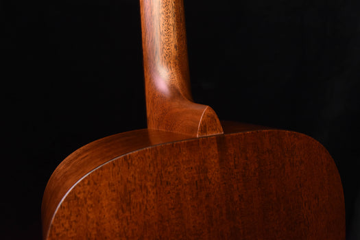 brown acoustic guitar side profile with neck joint and upper bout curve