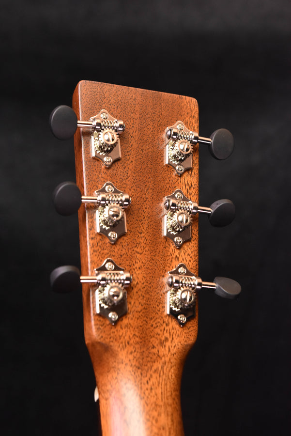 Acoustic guitar headstock with six tuning machines and chrome tuning buttons