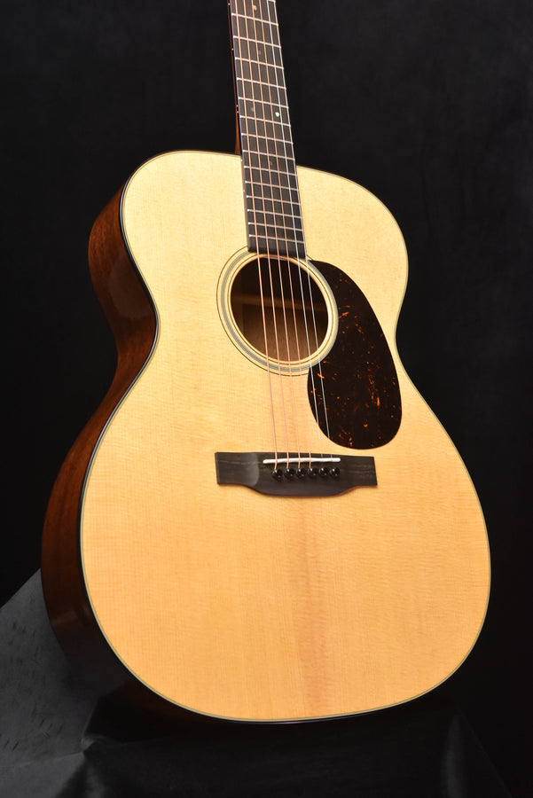 Martin acoustic guitar front view with rosette sound hole and bridge on light top