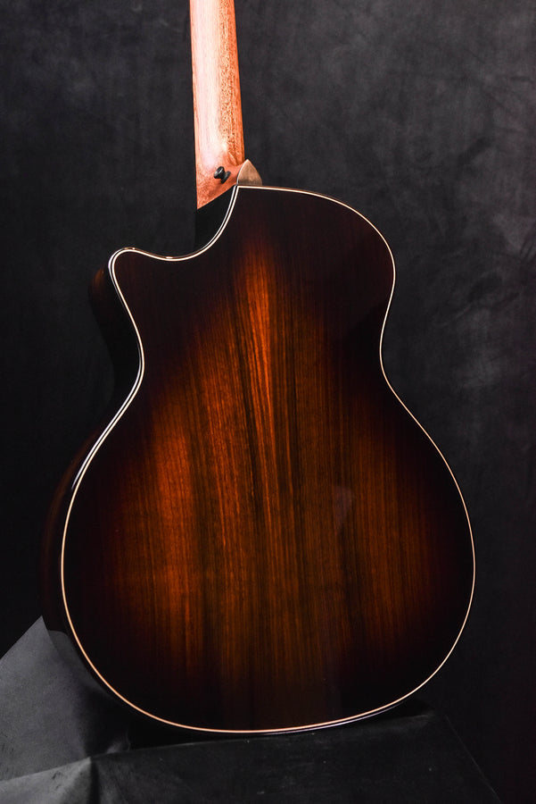Dark sunburst acoustic guitar back with binding and subtle center seam line.