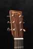 Martin acoustic guitar headstock with tuning pegs and engraved brand logo