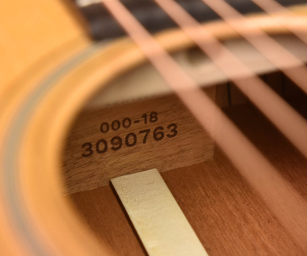 Acoustic guitar neck block with stamped model and serial numbers on wood