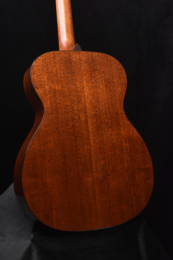 Martin acoustic guitar back view with warm brown figured wood finish