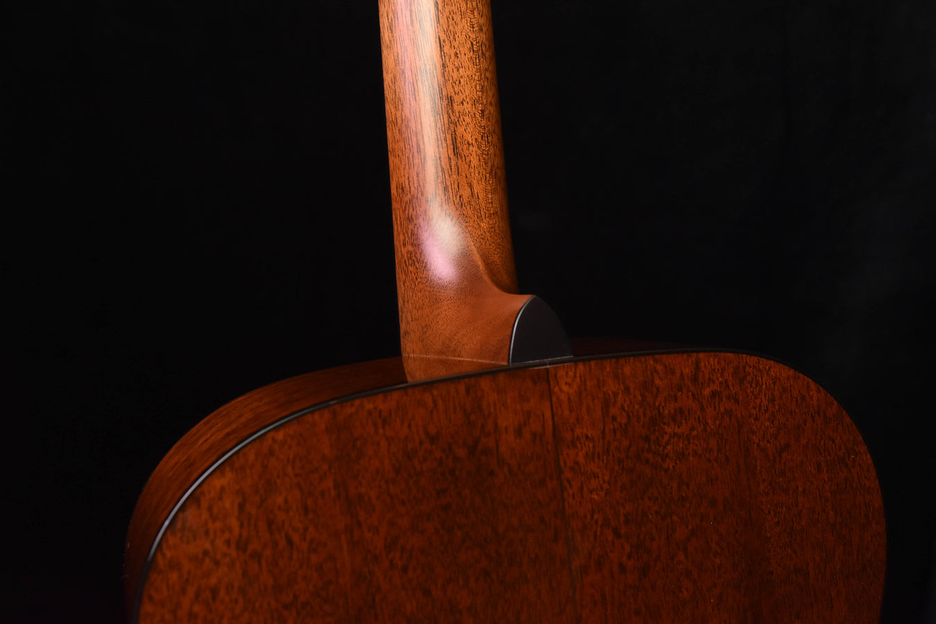 Acoustic guitar body with wooden neck joint and top curve, warm brown finish