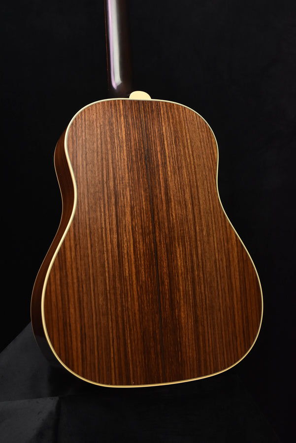 Gibson acoustic guitar back close-up with natural wood grain and side binding