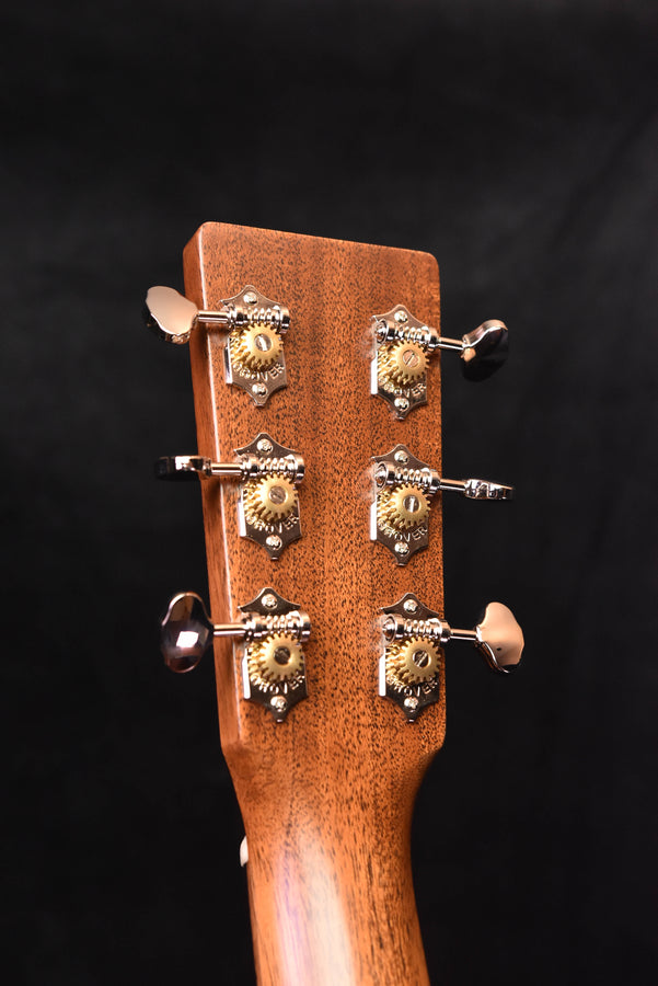 Martin acoustic guitar headstock with six tuning machines and circular knobs