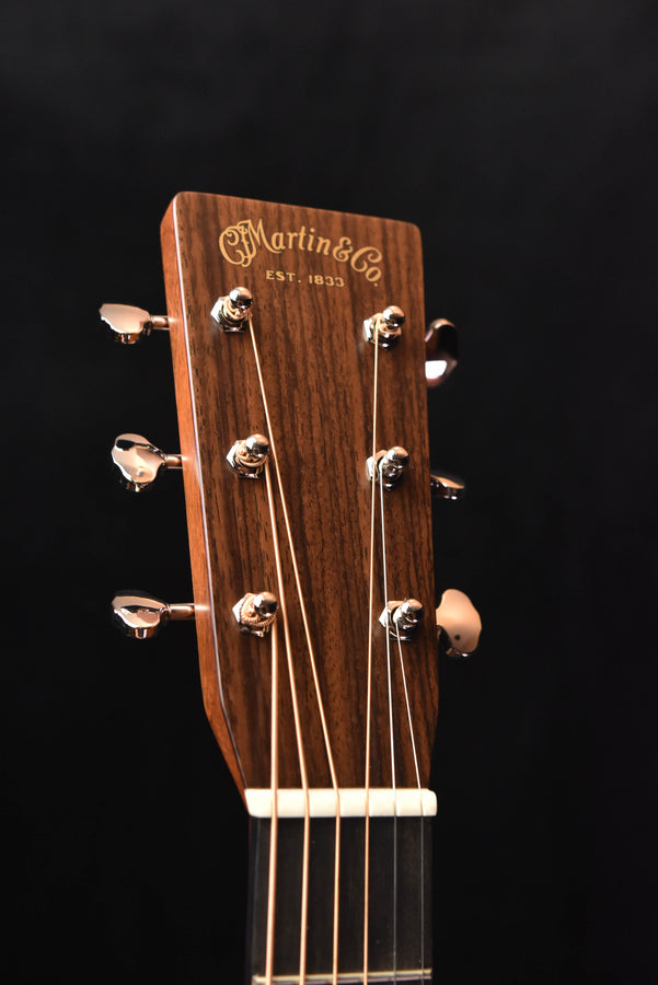 Acoustic guitar headstock with Martin logo and six tuning pegs