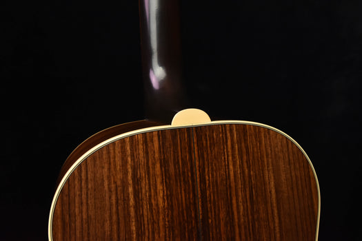 gibson acoustic guitar top back edge close-up with wooden finish and binding