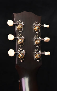 gibson acoustic guitar headstock back with six tuning pegs and engraved tuner plates