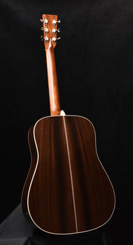 dreadnought acoustic guitar with dark wood body and headstock, angled view