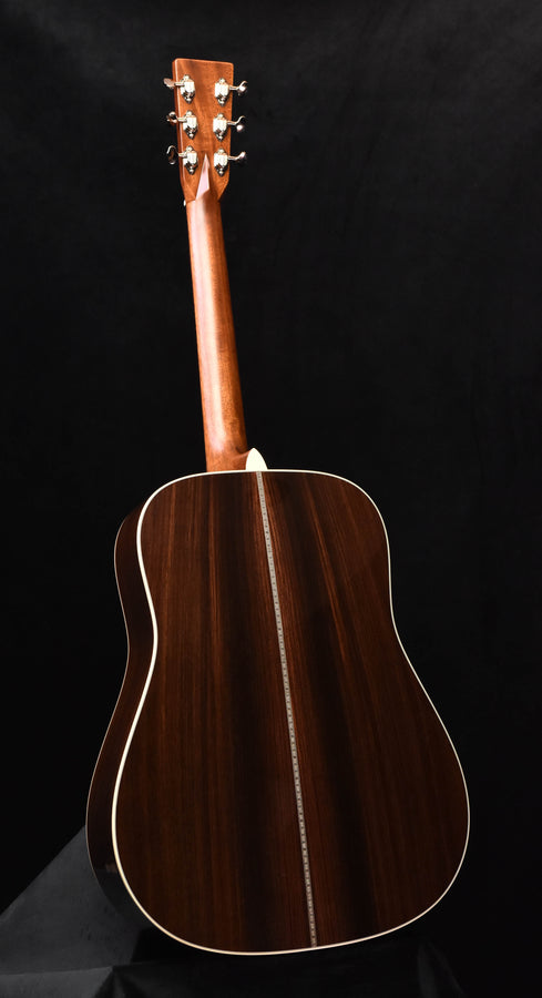 Dreadnought acoustic guitar with dark wood body and headstock, angled view