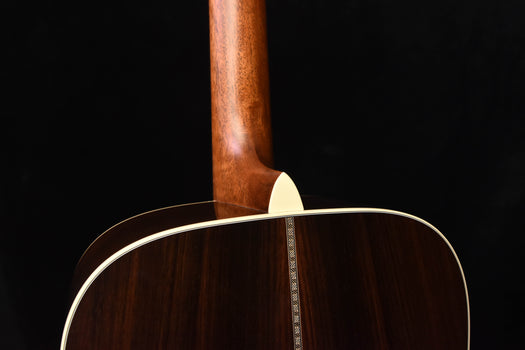 acoustic guitar top edge with light binding and vertical grain detail