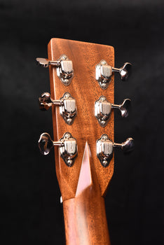 acoustic guitar headstock close-up with chrome tuning machine hardware