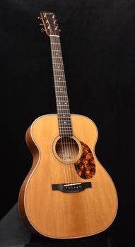 acoustic guitar with natural wood body, sound hole rosette, and dark fretboard