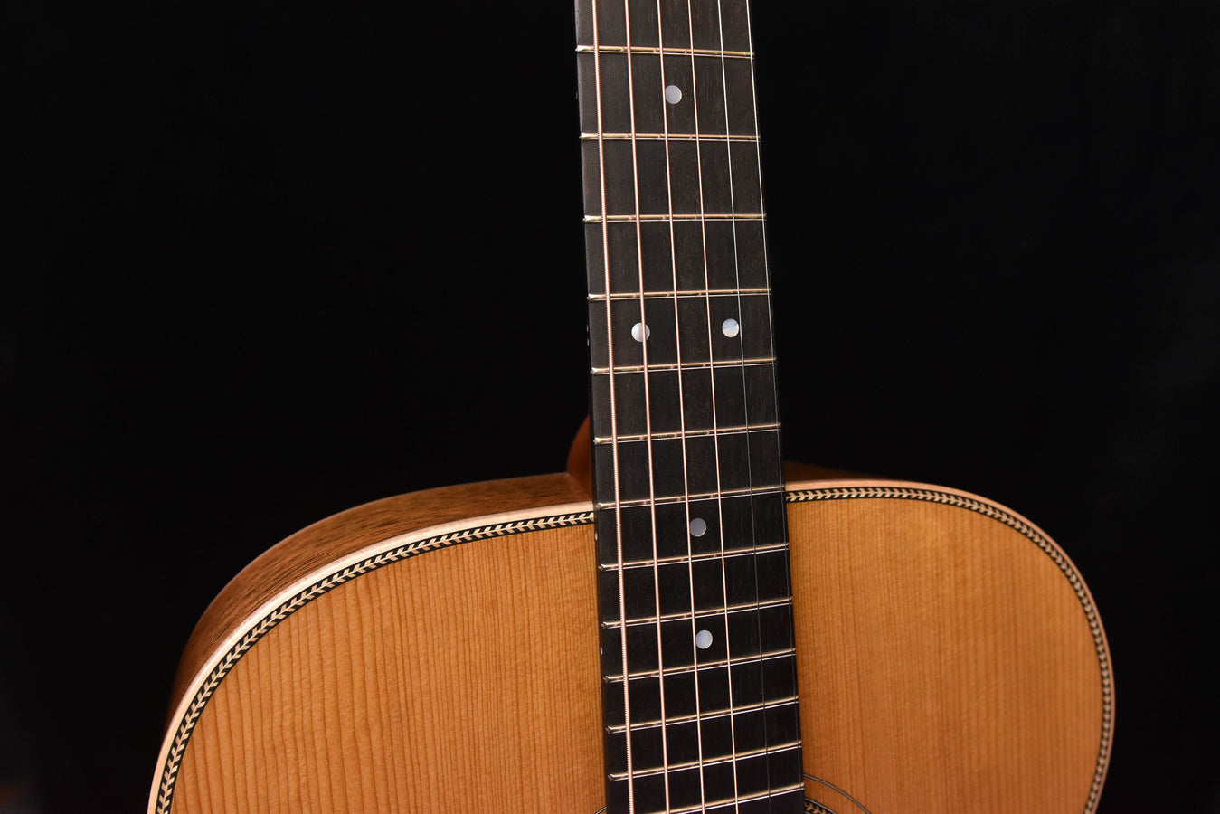 Acoustic guitar neck and frets with pearl dot inlays and natural wood headstock