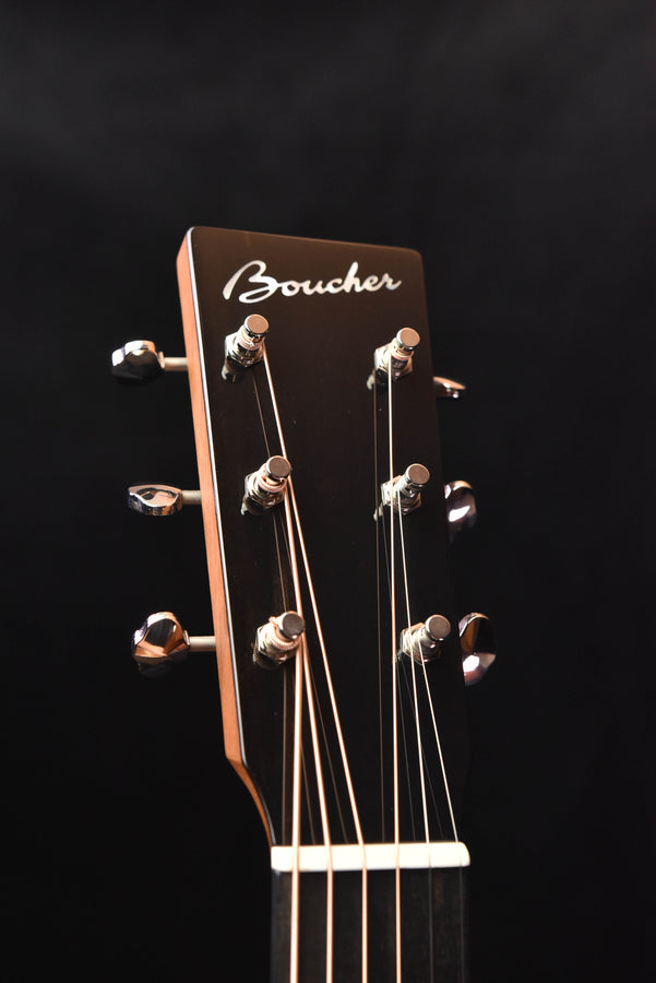 Boucher acoustic guitar headstock with tuning pegs and logo