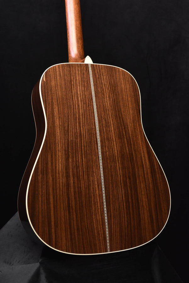 Brown acoustic guitar back with vertical grain pattern and white binding