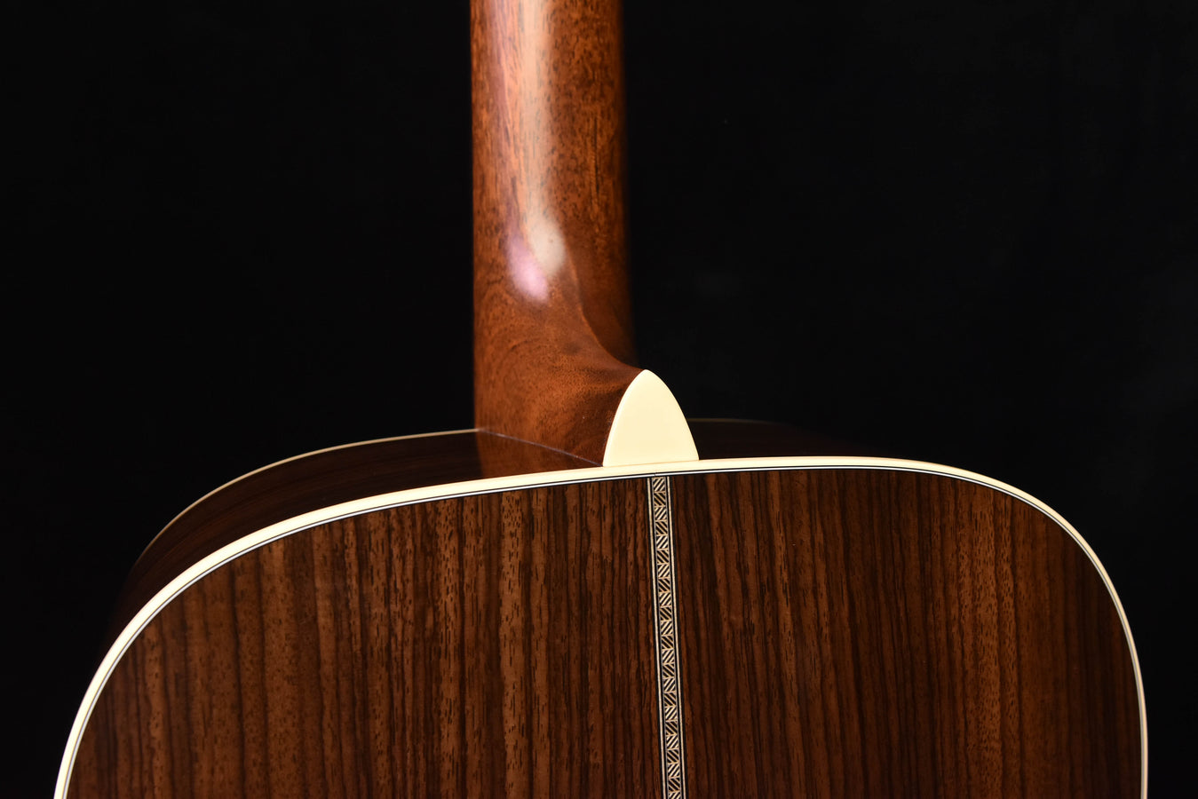 Acoustic guitar top near neck joint with white rosette trim