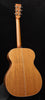 Acoustic guitar back view with natural wood finish and center seam