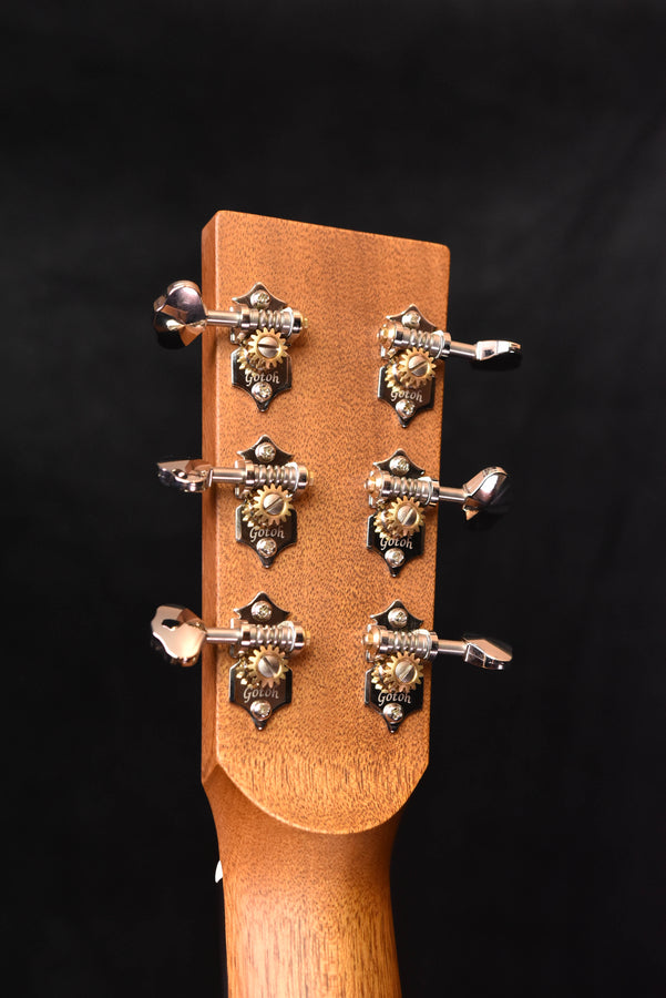 Acoustic guitar headstock with six tuning machines and chrome tuning hardware