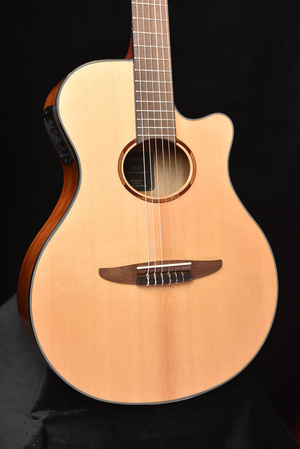 Nylon-string crossover acoustic-electric guitar, natural top with soundhole and bridge
