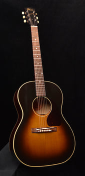 acoustic guitar with sunburst finish, rosette sound hole, and bridge with saddle