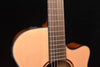 Guitar body and fretboard close-up, natural nylon-string acoustic-electric design