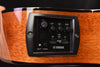 Onboard EQ and volume controls with Yamaha logo on acoustic-electric guitar preamp panel