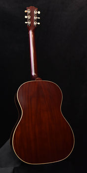 acoustic guitar back view with glossy dark wood body and cream edge binding