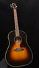 Sunburst acoustic guitar with dark fretboard and rosette around the sound hole