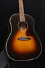 Sunburst acoustic guitar front view with pickguard and bridge detail
