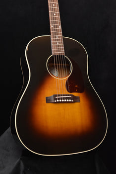 sunburst acoustic guitar front view with pickguard and bridge detail
