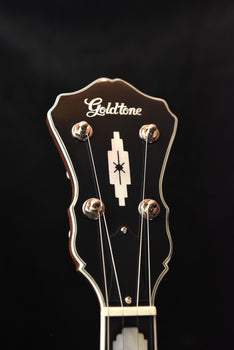 gold tone five-string banjo headstock with tuning pegs and logo, brown finish