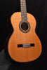 Classical nylon-string guitar with natural wood finish and black pickguard