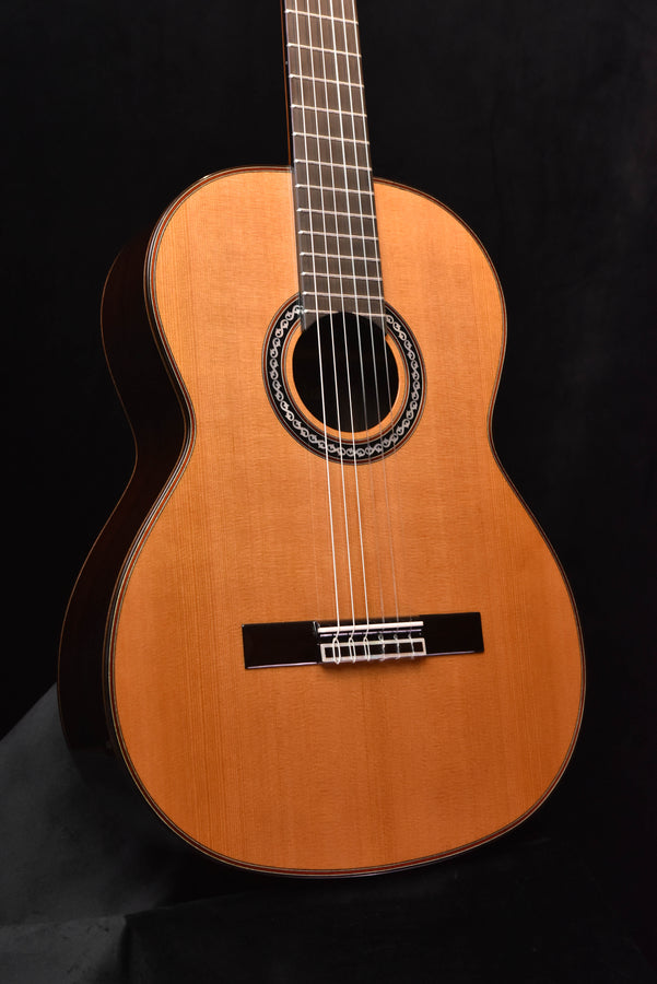 Classical nylon-string guitar with natural wood finish and black pickguard