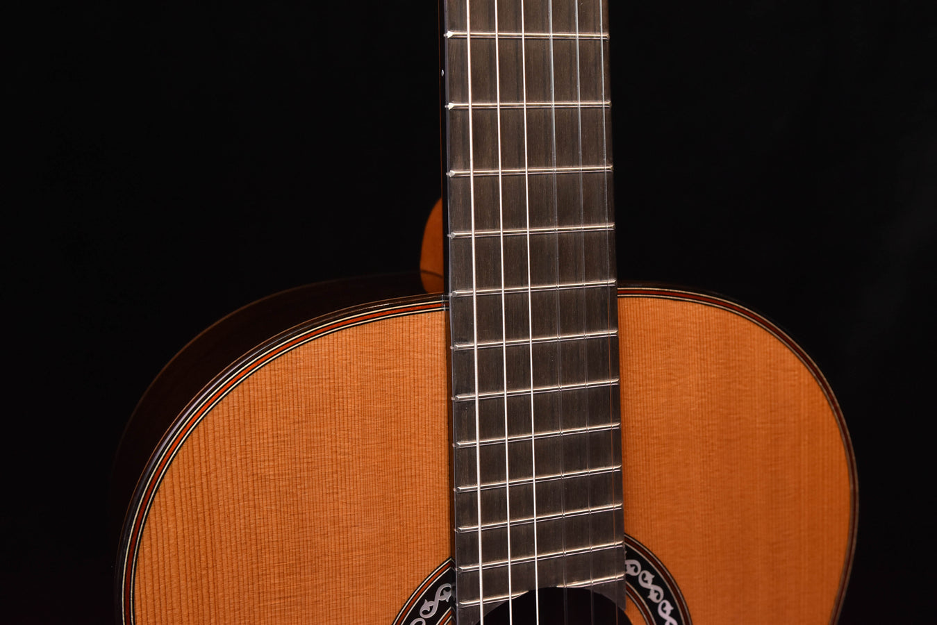 Classical guitar close-up of rosette sound hole and bridge strings