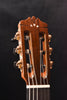 Classical guitar headstock with tuning pegs and glossy natural wood finish