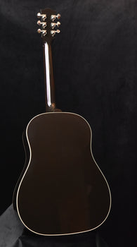 hollow-body acoustic guitar with dark top, glossy finish, and chrome tuners