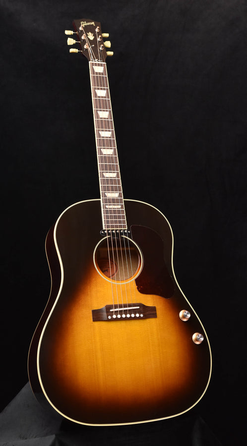 Sunburst acoustic-electric guitar with cutaway body and dot inlays