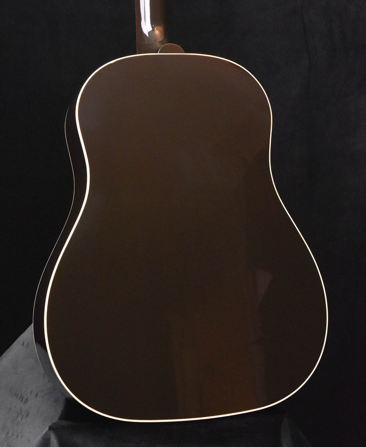 Hollow-body acoustic guitar body with dark top and white binding outline