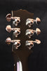 Gibson acoustic guitar headstock close-up with six chrome tuning pegs