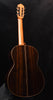 Classical guitar from back view with natural wood body finish