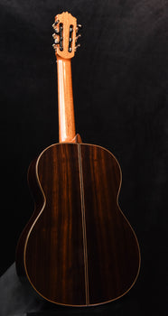 classical guitar from back view with natural wood body finish
